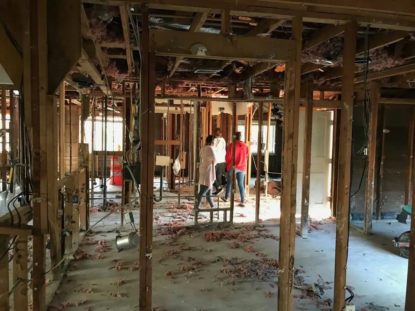 ami doing a walkthrough of a flooded house with the owner